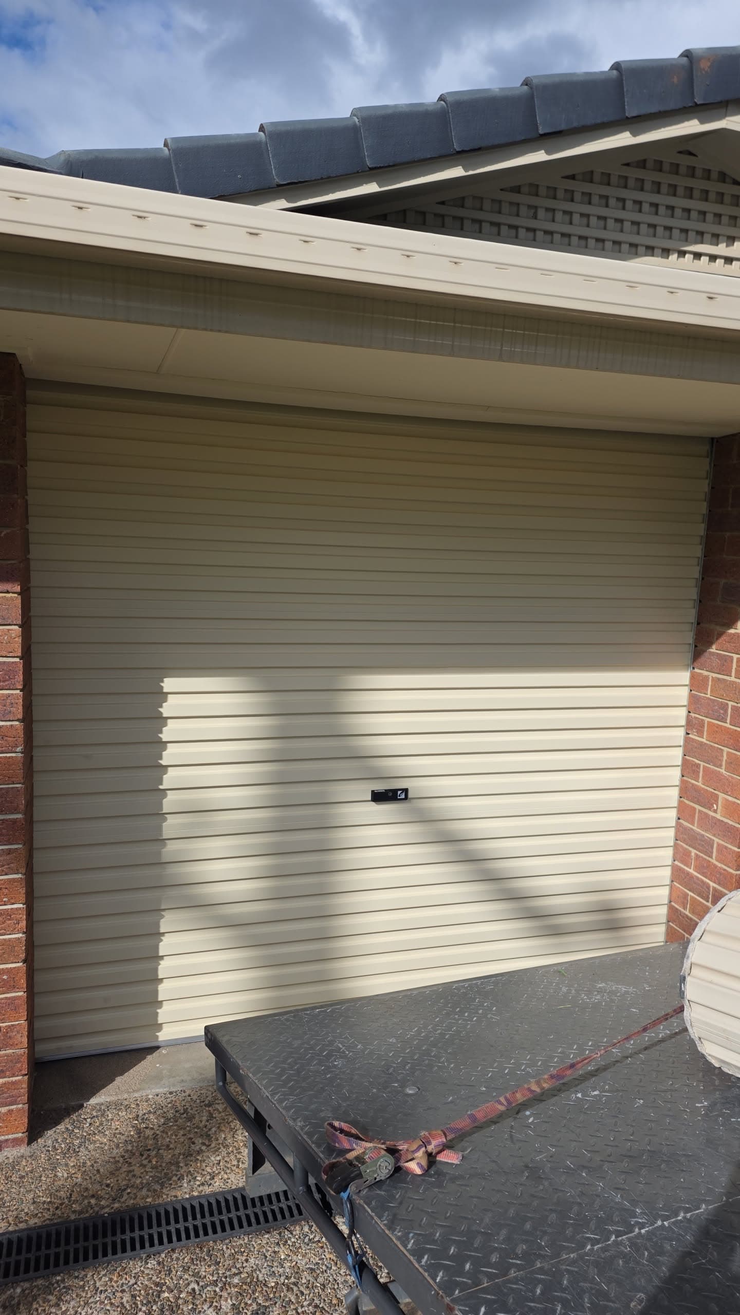New garage door being installed on the Sunshine Coast