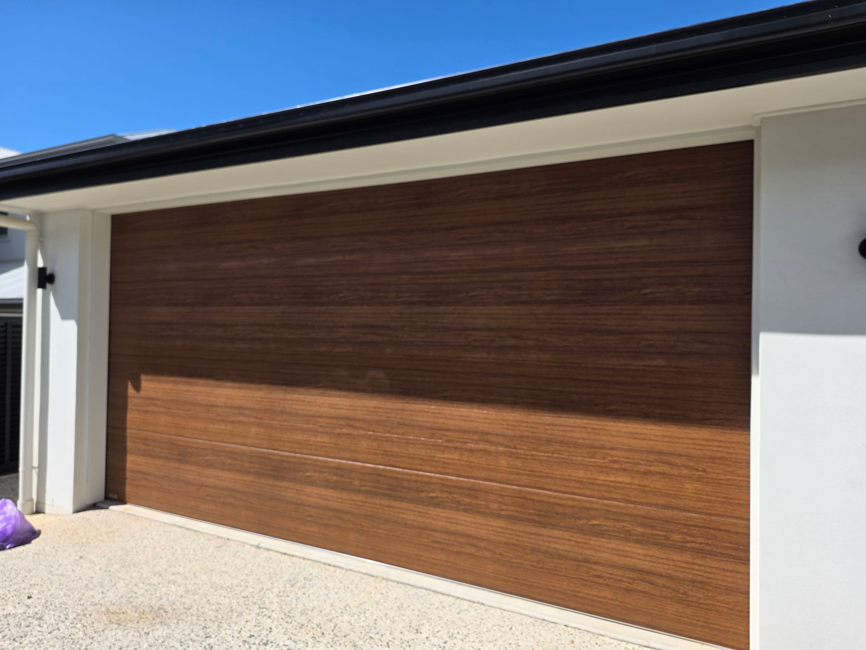 Woodgrain-look sectional garage door supplied by Deadlock